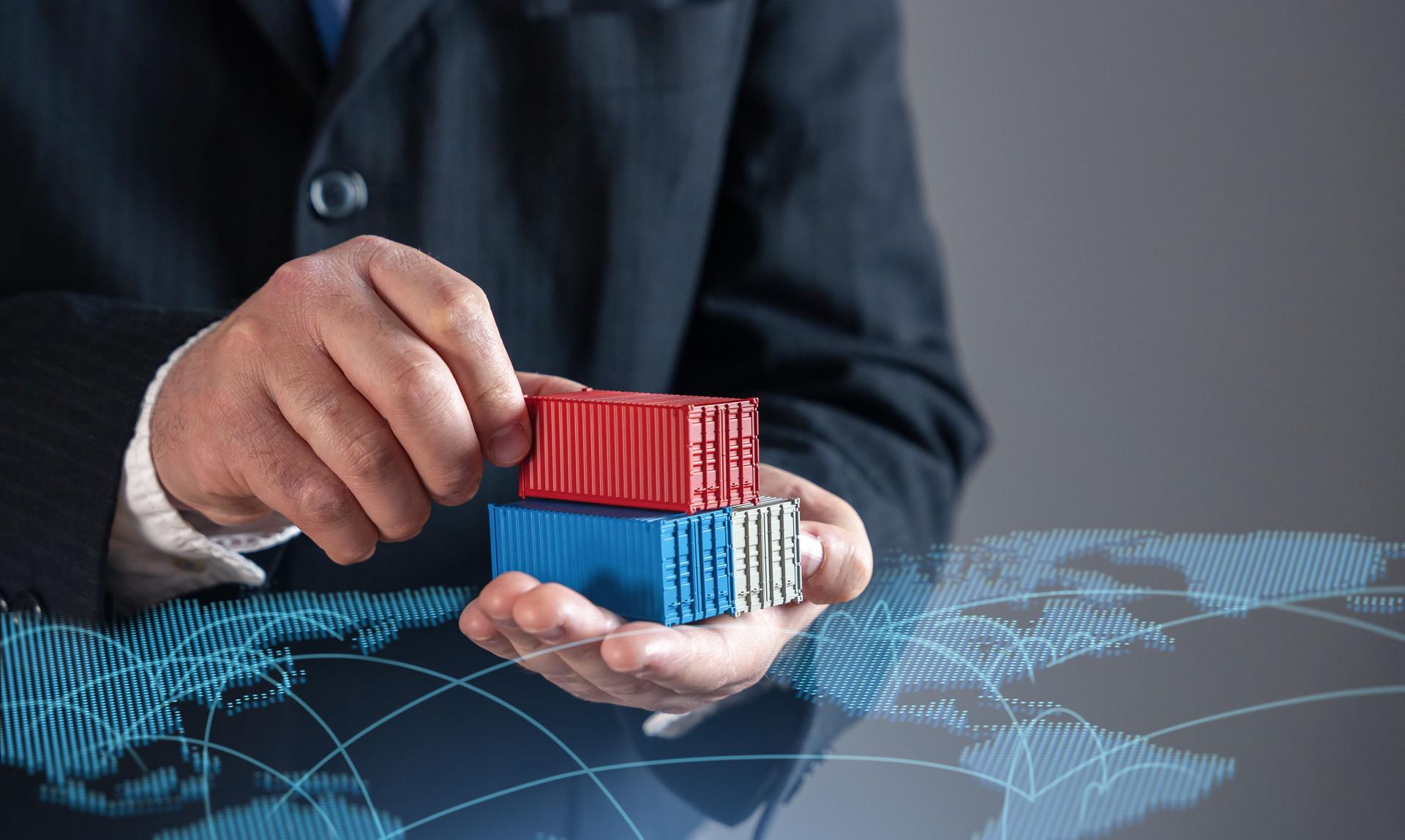 Businessman holding shipping containers against world trade map. Global trade, logistics, and commerce. Symbolizing international supply chains, exports, imports, and the expansion of global markets.